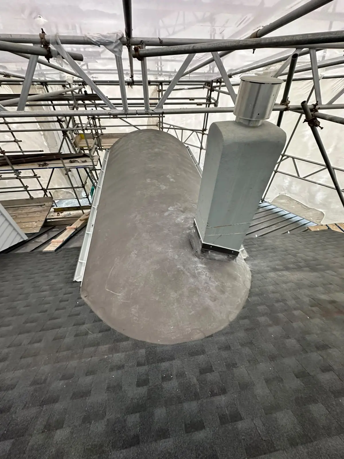 Barrel dormer under construction with membrane and flashing detailing