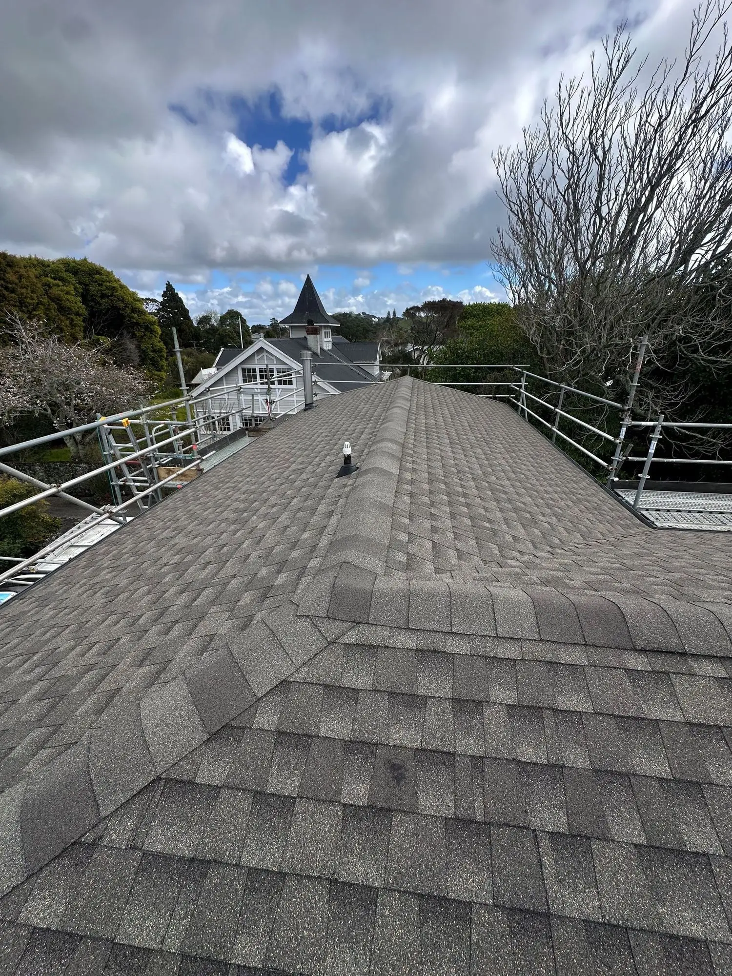 Completed asphalt shingle roof ridge on an Auckland property