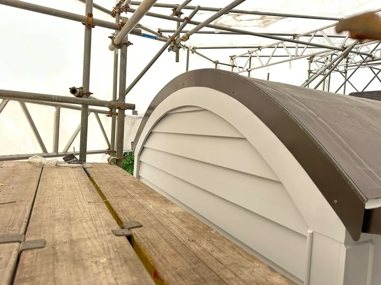Curved dormer finished with membrane and custom flashing