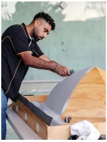 Harvinder Banga shaping a curved flashing on site in Auckland