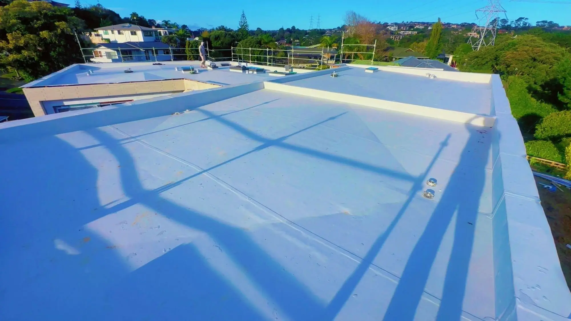 Large white membrane roof area with welded seams on an Auckland property