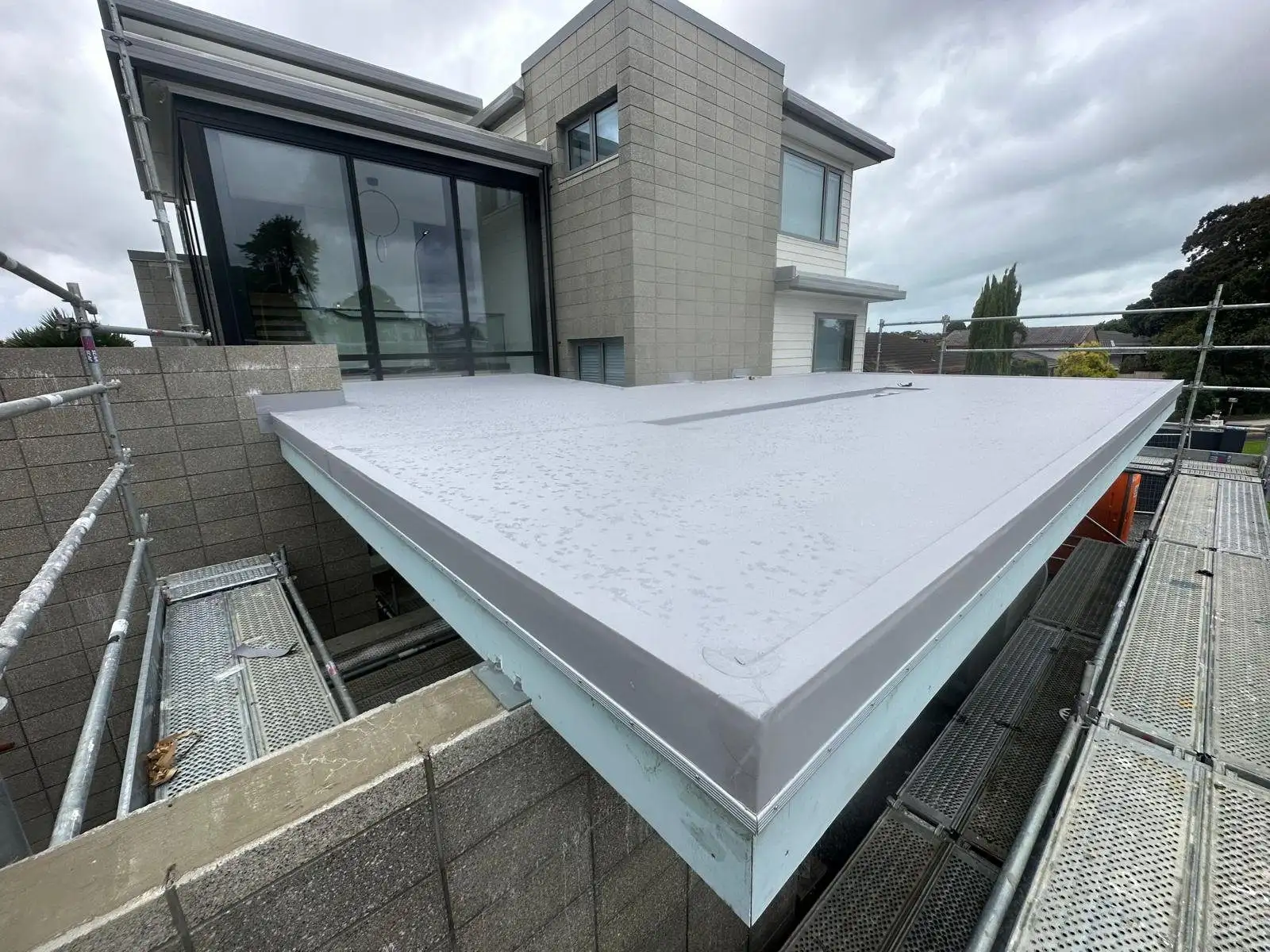 Membrane parapet cap detail on a modern Auckland home