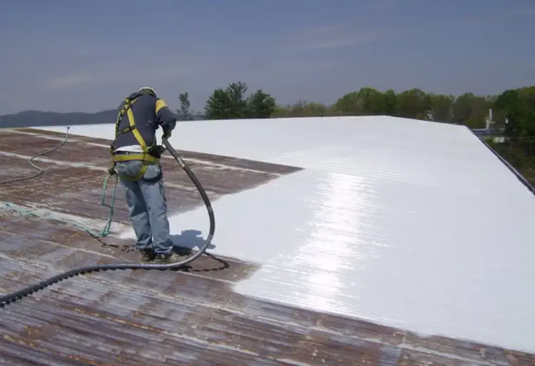 Roof coating being spray applied to an Auckland roof